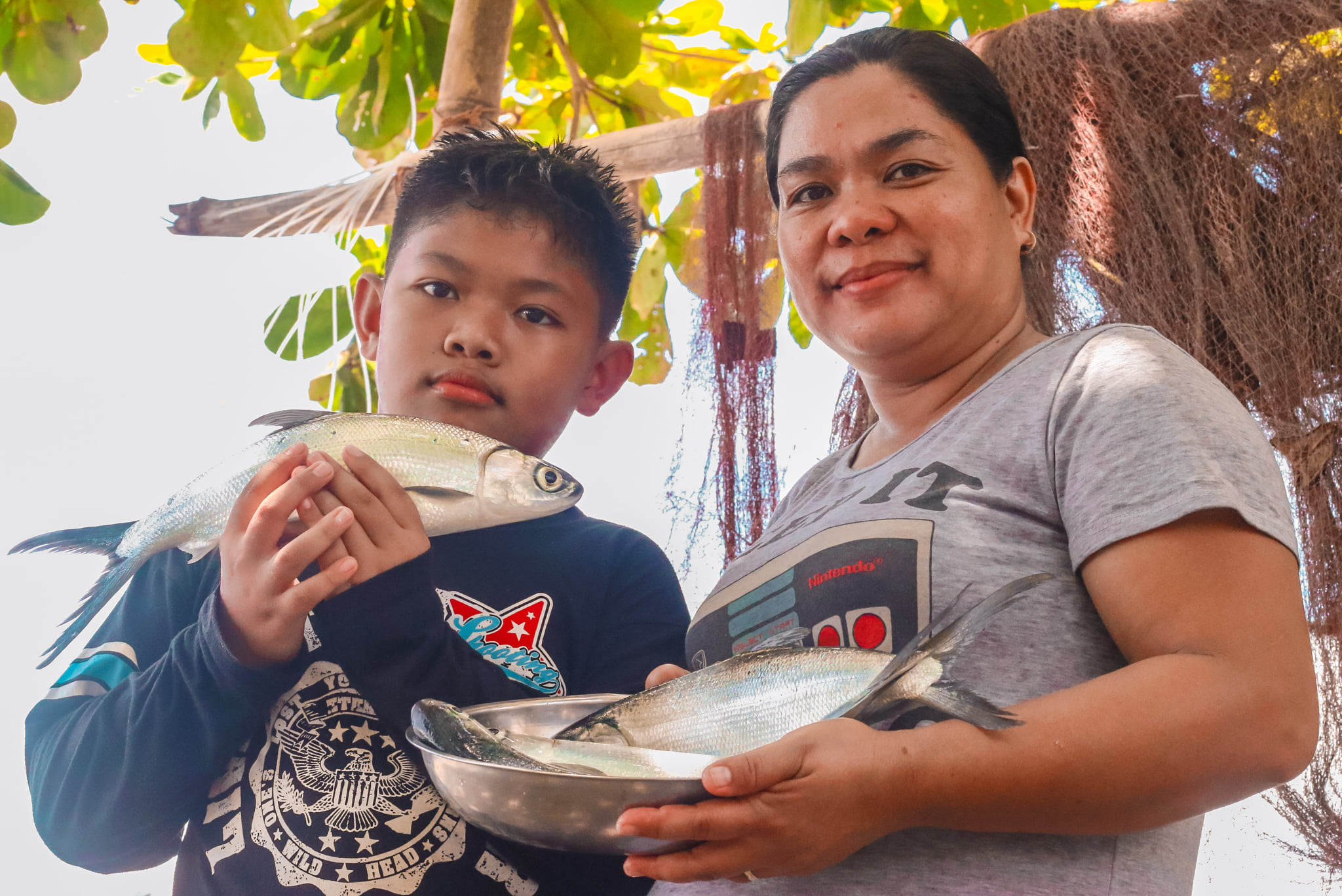 Southern Leyte fisher enjoys bountiful milkfish harvest from SAAD